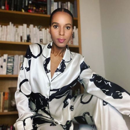 Kerry Washington in a white dress poses for a picture.